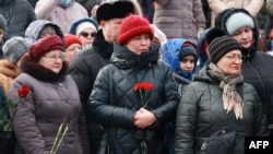 Mourners gather to lay flowers in memory of more than 60 Russian soldiers that Russia says were killed in a Ukrainian strike on Russian-controlled territory, in Samara, on Jan. 3, 2023.