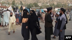 FILE - People walk through a street in Fayzabad of Badakhshan province, Sept. 15, 2022. A car bomb set off in the city, reportedly by IS-Khorasan, killed a provincial police chief and his two guards, according to Taliban authorities. 