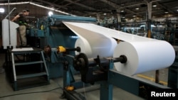 FILE - A worker prepares a roll of paper prior to running the presses in the La Prensa newspaper printing plant in Managua, Nicaragua Feb. 7, 2020. In 2022, La Prensa was forced to move its entire operation outside of the country.