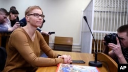 FILE - Marina Zolatava, editor-in-chief of the Belarusian independent news site Tut.by, sits in a courtroom prior to a court session in Minsk, Belarus, Feb. 12, 2019.