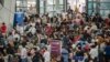 Passengers wait for information about their flights at terminal 3 of Ninoy Aquino International Airport in Pasay, Metro Manila, Philippines, Jan. 1, 2023.