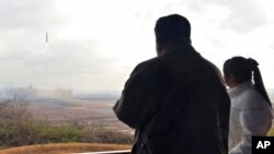 This photo provided Nov. 19, 2022, by the North Korean government shows North Korean leader Kim Jong Un and his daughter watching a missile launch at Pyongyang International Airport in Pyongyang, North Korea, Nov. 18, 2022.