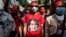 A protester wears a T-shirt depicting detained Myanmar civilian leader Aung San Suu Kyi during a demonstration outside the Embassy of Myanmar in Bangkok on Dec. 19, 2022.