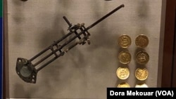 Counterfeit equipment and fake $10 gold coins made out of copper pennies on display at the U.S. Secret Service Museum.