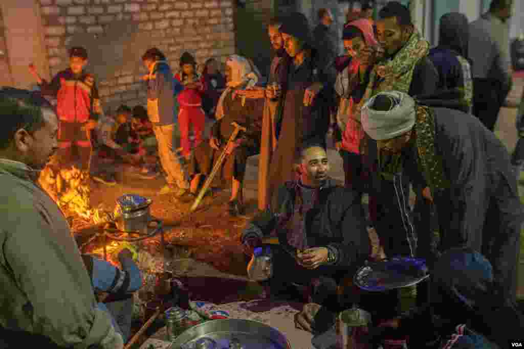 Attendees enjoy complimentary tea during Christmas celebrations in Al-Sherif, Egypt. (Hamada Elrasam/VOA)