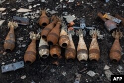 Unexploded mortar ammunitions are piled up on the ground in Kam'yanka, eastern Ukraine, Dec. 26, 2022.