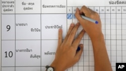 FILE - An election officer counts votes at a polling station in Bangkok, Thailand, March 24, 2019.