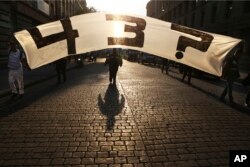 Relatives of 43 missing college students, from Mexico's Guerrero state, mark the 43rd month since their disappearances, with a march in Mexico City, April 26, 2018. Two years ago, several students and bystanders were killed and 43 students vanished in the city of Iguala, allegedly taken by police and then handed over to a criminal gang who burned their bodies in a garbage dump, according to a federal investigation.