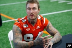 FILE - Lou Hedley, seen here on Aug. 13, 2019, in Coral Gables, Florida, did work for a Miami-based company when he was home in Australia so he could earn money this summer. (AP Photo/Wilfredo Lee)