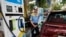 An employee of a Bharat petroleum fuel station fills up a vehicle in Mumbai, June 11, 2022. 
