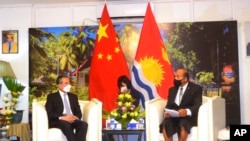 In this photo released by Xinhua News Agency, Kiribati President and Foreign Minister Taneti Maamau, right, meets with Chinese Foreign Minister Wang Yi in Tarawa, Kiribati, May 27, 2022. 