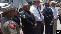 FILE - Uvalde School Police Chief Pete Arredondo, third from left, stands during a news conference outside Robb Elementary school in Uvalde, Texas, on May 26, 2022.
