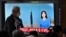 A man walks past a screen showing a news broadcast with file footage of a North Korean missile test, at a railway station in Seoul, South Korea, June 5, 2022.