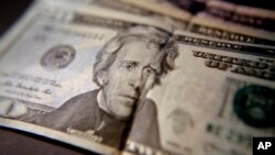 FILE - U.S. household income fell for the first time in two years, mostly due to declines in the stock market. This June 13, 2018, photo shows U.S. currency. 