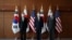 Kim Gunn, South Korea's new special representative for Korean Peninsula peace and security affairs, his U.S. counterpart Sung Kim and Japanese counterpart Takehiro Funakoshi pose for photographs before their meeting at the Foreign Ministry in Seoul, South Korea, June 3, 2022. 