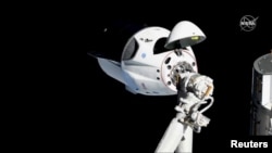 FILE - The SpaceX Crew Dragon capsule approaches the International Space Station, March 3, 2019. 