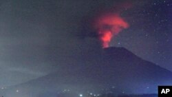 A view of the Mount Agung volcano erupting, in Karangasem, Bali island, Indonesia, early Sunday, Nov. 26, 2017.