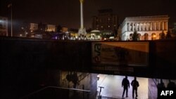 Pedestrians walk an underground pass during a power cut at Independence Square in downtown Kyiv on Nov. 10, 2022, amid the Russian invasion of Ukraine.