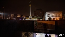 Pedestrians walk an underground pass during a power cut at Independence Square in downtown Kyiv on Nov. 10, 2022, amid the Russian invasion of Ukraine.