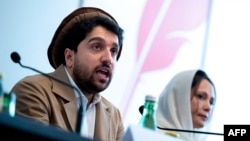 FILE - Ahmad Massoud, left, leader of the National Resistance Front of Afghanistan, and Aliya Yilmaz, Afghan women's rights activist, speak to journalists at Concordia Press Club on the occasion of the intra-Afghanistan conference in Vienna, Austria, Sept. 16, 2022.