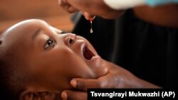 A baby recieves a vitamin booster during a measles vaccination drive at a clinic in Harare, Zimbabwe, Thursday, Sept. 15, 2022. (AP Photo/Tsvangirayi Mukwazhi)