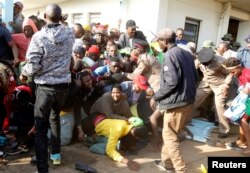 People fall into a stampede as they jostle to attend the inauguration of Kenya's President William Ruto, before his swearing-in ceremony at the Moi International Stadium Kasarani in Nairobi, Sept. 13, 2022.
