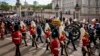 The coffin of Queen Elizabeth II with the Imperial State Crown resting on top, borne on the State Gun Carriage of the Royal Navy proceeds past Buckingham Palace in London, during the state funeral of Queen Elizabeth II, Monday Sept. 19, 2022. (Jenny Gooda