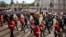 The coffin of Queen Elizabeth II with the Imperial State Crown resting on top, borne on the State Gun Carriage of the Royal Navy proceeds past Buckingham Palace in London, during the state funeral of Queen Elizabeth II, Monday Sept. 19, 2022. (Jenny Gooda