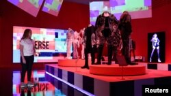 A gallery assistant looks at "K-pop - exporting hallyu to the world" during the press view of "Hallyu! The Korean Wave" exhibition at the V&A in London, Britain, September 21, 2022. (REUTERS/Tom Nicholson)