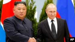 FILE - Russian President Vladimir Putin, right, and North Korea's leader Kim Jong Un shake hands during their meeting in Vladivostok, Russia, April 25, 2019.