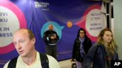Vladimir, a passenger from the Moscow-Belgrade flight operated by Air Serbia, speaks to the media at the airport in Belgrade, Serbia, Sept. 21, 2022.