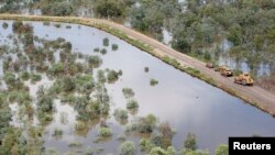 FILE- An aerial view of a road along flooded land caused by La Nina in the town of Goodooga, New South Wales, Australia, January 6, 2011. (REUTERS/Shawn Damian/File)