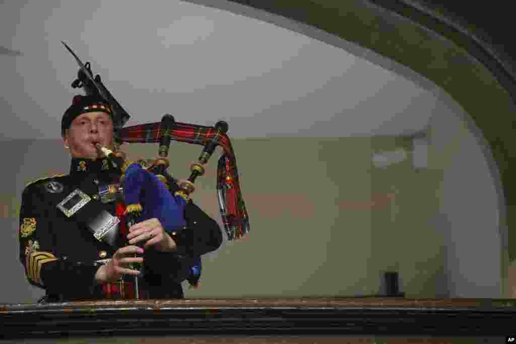 A piper plays during the funeral of Queen Elizabeth at Westminster Abbey in London, Sept. 19, 2022.