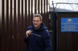 FILE - Russian opposition leader Alexei Navalny walks out of a detention center after he was jailed for 30 days for calling an unauthorized protest in Moscow, Aug. 23, 2019.