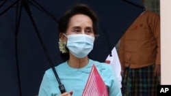 FILE - Myanmar Leader Aung San Suu Kyi leaves after the Central Executive Committee meeting at her National League for Democracy (NLD) party headquarters in Naypyitaw, Myanmar on July 21, 2020.