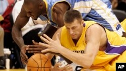 FILE - Los Angeles Lakers' Slava Medvedenko, right, of Ukraine, and Denver Nuggets' Francisco Elson, top, of the Netherlands, dive for the ball in the first quarter of a preseason NBA basketball game in Los Angeles, California, Oct. 20, 2005.