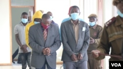 FILE - Some of the 12 people who were sentenced with Thomas Muhosha in connection with the murder of an albino man are seen in court in Malawi, in June 2022. (Lameck Masina/VOA)
