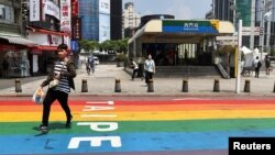 A man runs to find cover during the annual air-raid exercise named Wan An – a reminder of how to respond during a military threat – during which vehicles are ordered to move to the sides of roads and pedestrians are told to wait in back streets.