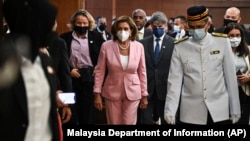 This handout photo taken and released by Malaysia’s Department of Information, U.S. House Speaker Nancy Pelosi, center, tours the parliament house in Kuala Lumpur, Aug. 2, 2022. Pelosi arrived in Malaysia on Tuesday for the second leg of an Asian tour.