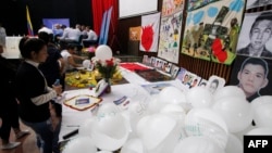 FILE - Relatives of victims attend a hearing organized by the Special Jurisdiction for Peace in Ocana, Colombia, on April 27, 2022. For the first time, a Colombian army general was indicted for the murder of more than 100 civilians by soldiers under his command.