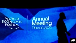 Workers set the stage prior to the annual meeting of the World Economic Forum, in Davos, Switzerland, Sunday, May 22, 2022. 