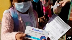 资料照片：2022年2月11日，美国加利福尼亚州萨克拉门托哈克尼斯小学向学生发放新冠病毒家庭测试包。 (美联社照片)