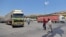 FILE - A convoy transporting humanitarian aid crosses into Syria from Turkey through the Bab al-Hawa border crossing on July 8, 2022. 