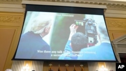 As Eric Herschmann, former White House adviser, speaks on a video, a photo of President Donald Trump recording a video on Jan. 6 is displayed, as the House select committee investigating the Jan. 6 attack on the U.S. Capitol holds a hearing July 21, 2022.