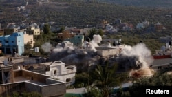 Pasukan Israel meledakkan rumah penyerang militan Palestina Yahya Mari, di Qarawat Bani Hassan di Tepi Barat yang diduduki Israel 26 Juli 2022. (REUTERS/Mohamad Torokman)