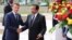 Cameroon's President Paul Biya shakes hands with his French counterpart Emmanuel Macron at the presidencial palace in Yaounde, Cameroon, July 26, 2022. 
