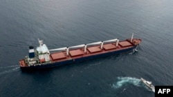 FILE - The Sierra Leone-flagged cargo vessel Razoni en route to Tripoli, Lebanon, along the Bosphorus Strait, Aug. 3, 2022, after being inspected. Inspections of ships carrying Ukrainian grain and other food exports have slowed to half their peak rate.