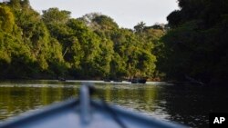FILE - A boat moves through the water in Cristalino II State Park in the state of Mato Grosso, in Brazil, July 22, 2019. (Rodrigo Vargas via AP)