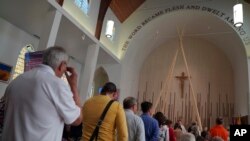 FILE - Parishioners stand to receive communion during the rededication ceremony and Sunday Mass at Sacred Heart Church of the First Peoples, in Edmonton, Alberta, July 17, 2022. 
