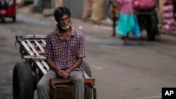 A laborer waits for work at a wholesale market in Colombo, Sri Lanka, Sunday, June 26, 2022. (AP Photo/Eranga Jayawardena)